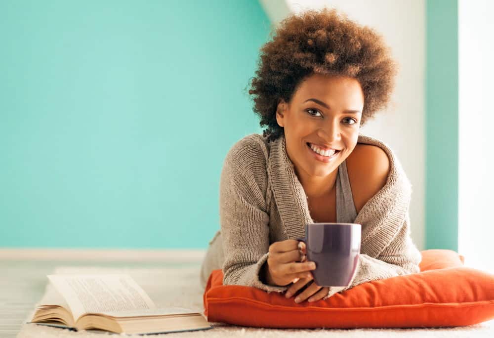 A young black woman shows off her porcelain veneers.