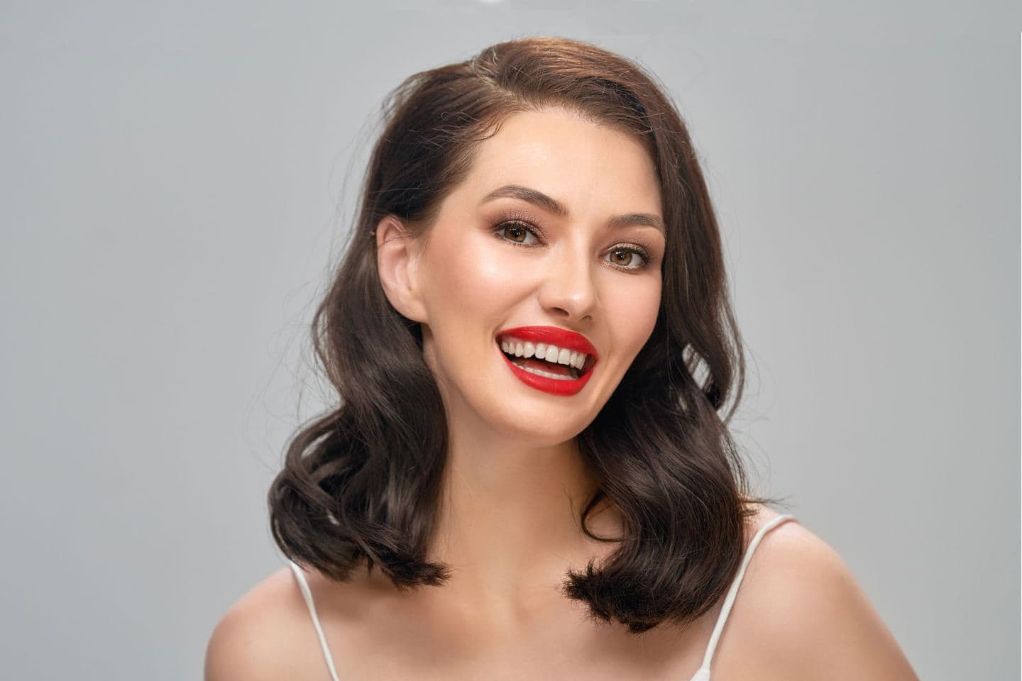 A young woman shows off her new smile after having a Smile Makeover.